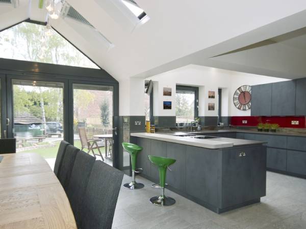 A modern kitchen with green bar stools